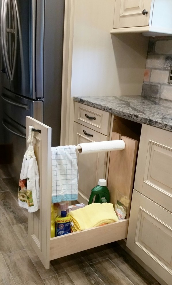 Inspiration for a large light wood floor kitchen remodel with raised-panel cabinets, white cabinets, quartzite countertops, multicolored backsplash, subway tile backsplash, stainless steel appliances and an island
