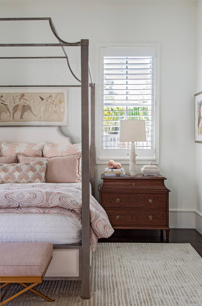 Design ideas for a beach style bedroom in Charleston with white walls, dark hardwood floors and brown floor.