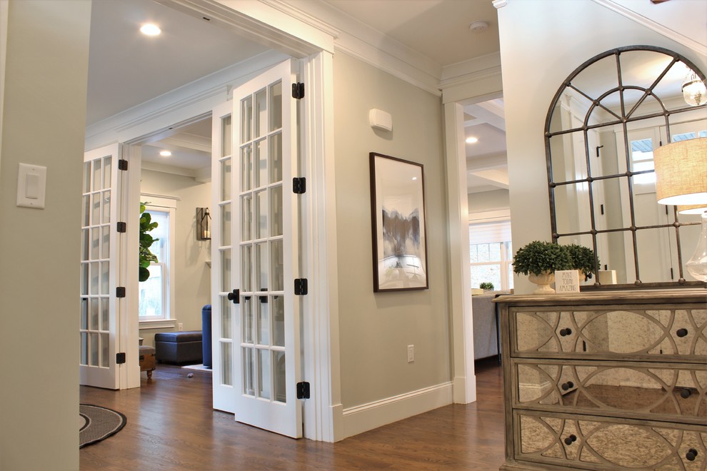 Mid-sized transitional dark wood floor and brown floor foyer photo in Boston with gray walls and a white front door