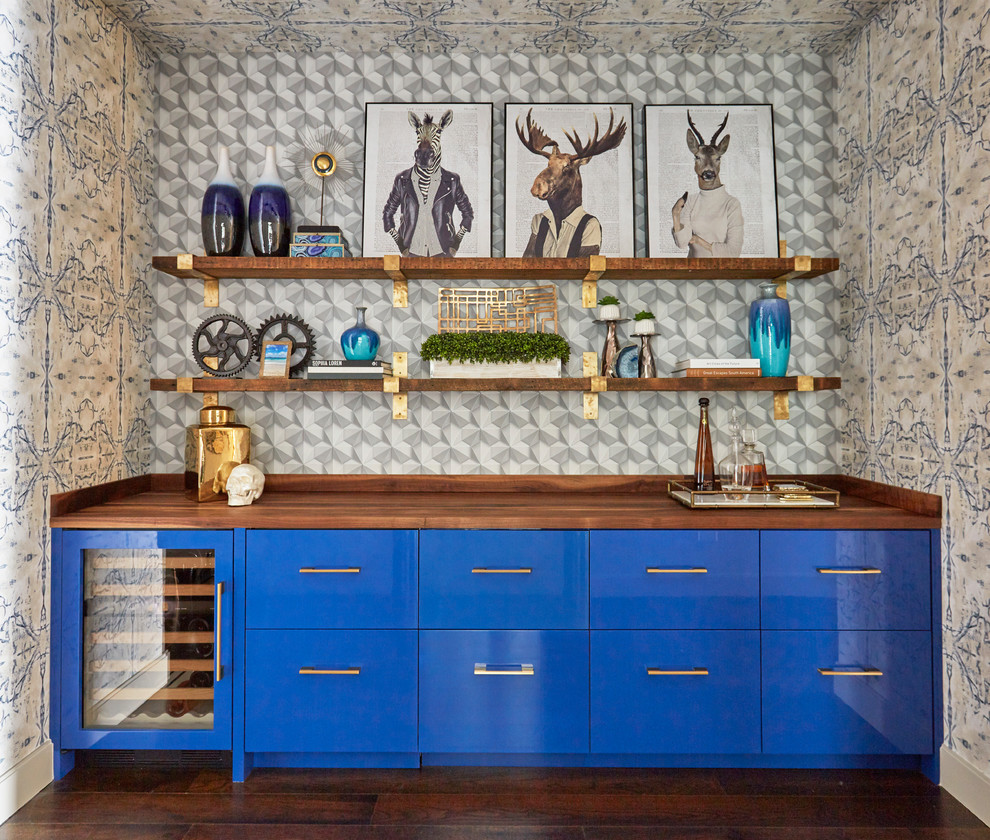 Design ideas for a contemporary single-wall home bar in Chicago with no sink, flat-panel cabinets, blue cabinets, wood benchtops, multi-coloured splashback, dark hardwood floors and brown benchtop.