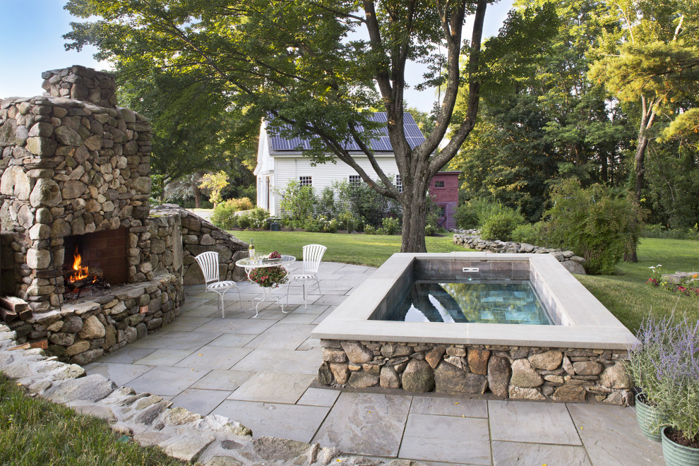 Design ideas for a small country backyard rectangular natural pool in Boston with a hot tub and natural stone pavers.