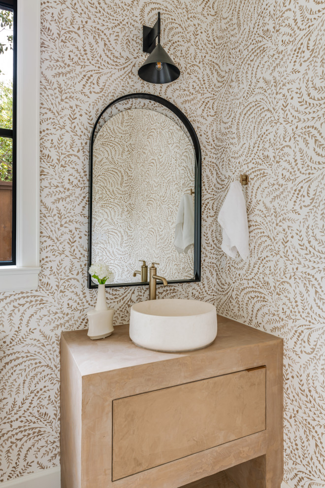 Example of a transitional wallpaper powder room design in Dallas with flat-panel cabinets, beige cabinets, beige walls and a vessel sink