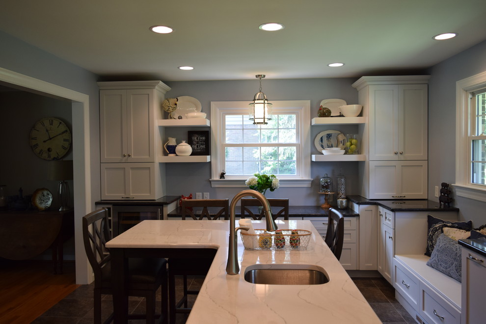 Example of a large classic l-shaped terra-cotta tile kitchen design with shaker cabinets, white cabinets, quartz countertops, blue backsplash, porcelain backsplash, stainless steel appliances and an island