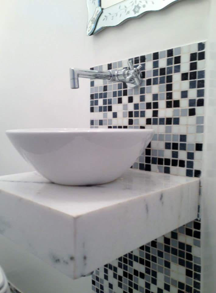 Photo of a small contemporary 3/4 bathroom in DC Metro with beaded inset cabinets, white cabinets, a one-piece toilet, black and white tile, mosaic tile floors, a vessel sink, black floor and white benchtops.