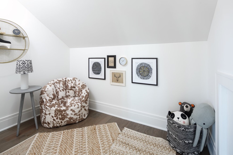 Photo of a beach style gender-neutral kids' playroom in Louisville with white walls and dark hardwood floors.