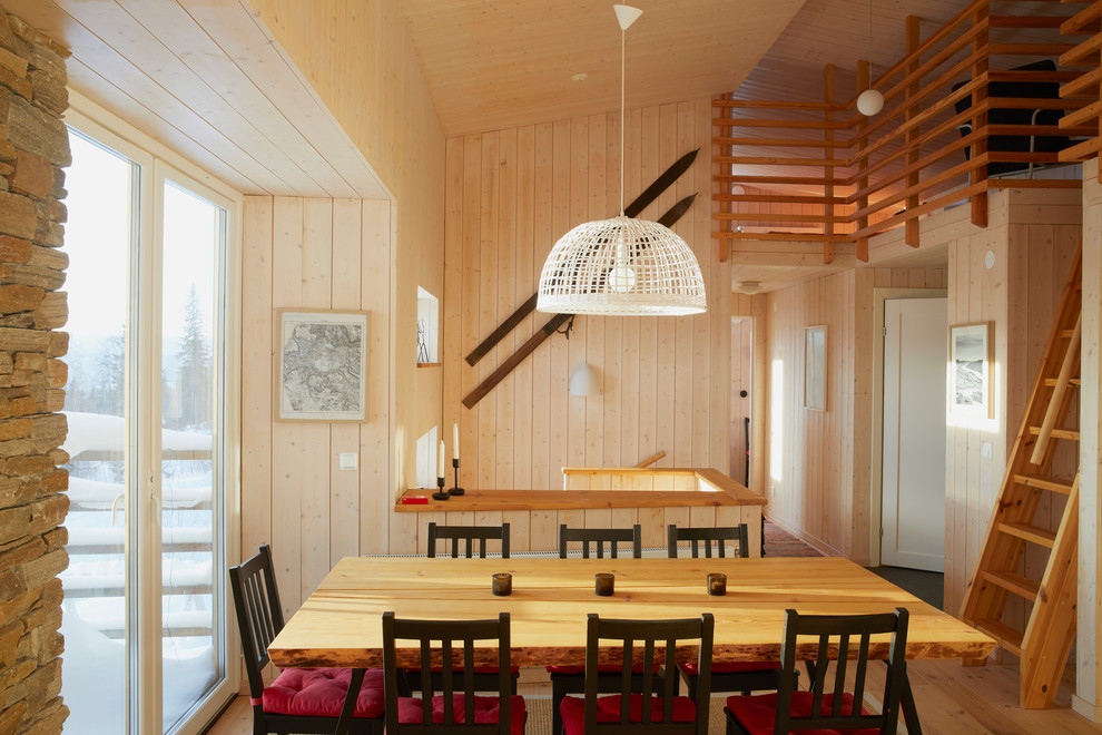 Country dining room in Malmo with light hardwood floors and no fireplace.
