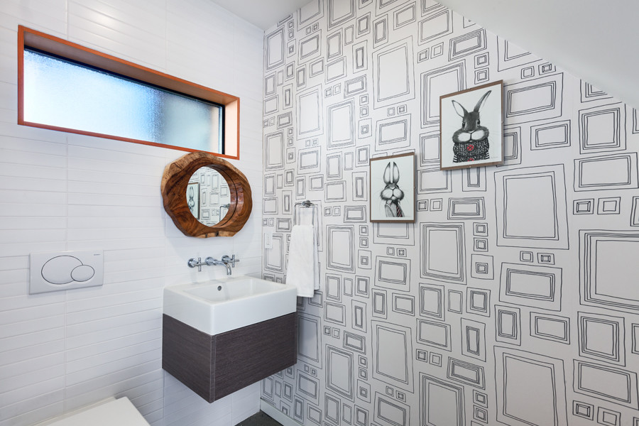 Contemporary powder room in Vancouver with a wall-mount sink, flat-panel cabinets, dark wood cabinets, a wall-mount toilet, white tile, ceramic tile and white walls.