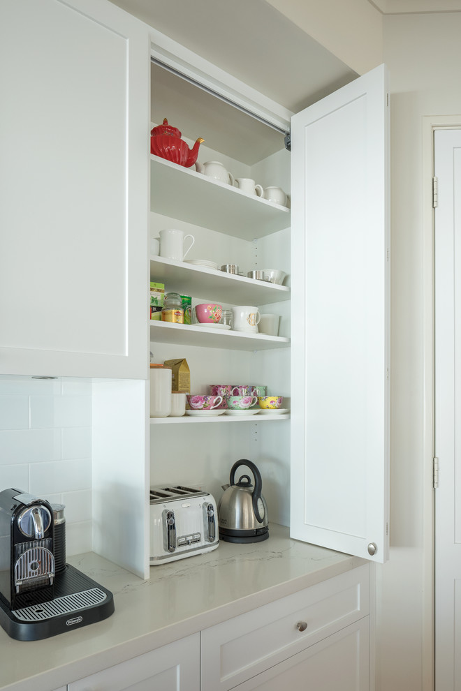 Design ideas for a transitional kitchen in Perth with shaker cabinets, white cabinets, quartz benchtops, white splashback, porcelain splashback and grey benchtop.