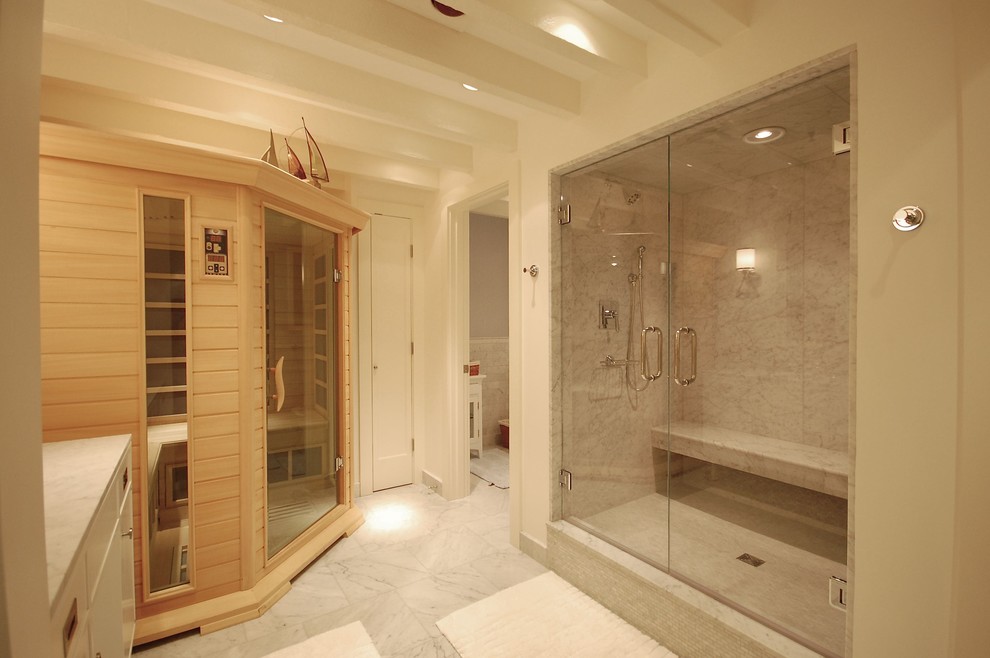 This is an example of a large contemporary bathroom in Boston with flat-panel cabinets, white cabinets, an alcove shower, gray tile, white tile, marble, white walls, marble floors, with a sauna, an undermount sink, marble benchtops and a hinged shower door.