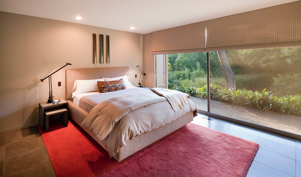 This is an example of a large contemporary guest bedroom in Santa Barbara with beige walls and no fireplace.