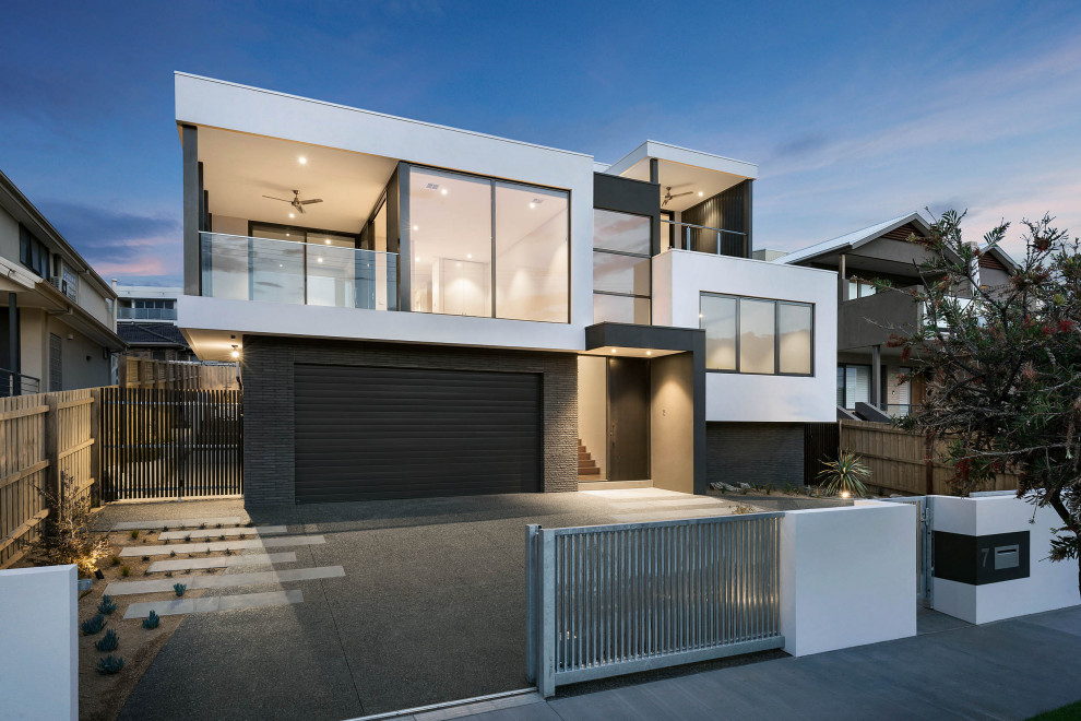 Design ideas for a modern two-storey multi-coloured house exterior in Melbourne with mixed siding and a flat roof.
