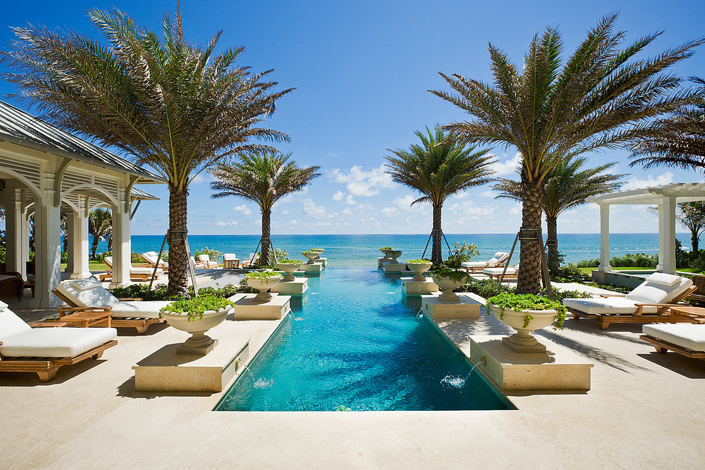 Design ideas for a tropical rectangular pool in Miami with a water feature.