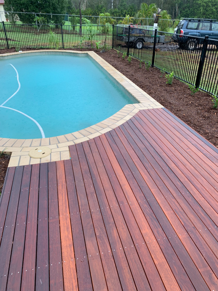World-inspired swimming pool in Brisbane with with pool landscaping and decking.