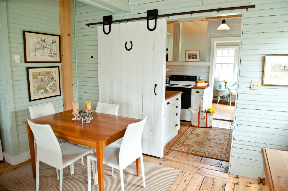 Photo of a traditional dining room in Portland Maine with green walls and light hardwood floors.