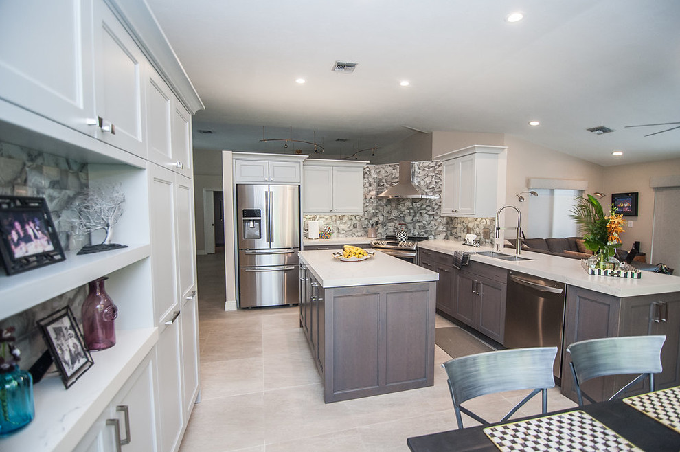 Inspiration for a mid-sized transitional u-shaped porcelain tile and beige floor eat-in kitchen remodel in Miami with an undermount sink, shaker cabinets, gray cabinets, quartz countertops, gray backsplash, glass tile backsplash, stainless steel appliances, an island and white countertops