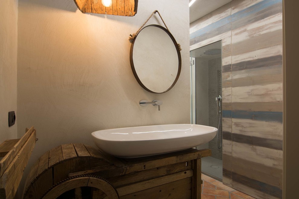 This is an example of a small beach style master bathroom in Florence with raised-panel cabinets, light wood cabinets, a corner shower, a two-piece toilet, beige walls, terra-cotta floors, an integrated sink and concrete benchtops.