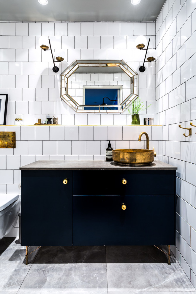 Inspiration for a mid-sized transitional powder room in Stockholm with flat-panel cabinets, black cabinets, white tile, white walls, a vessel sink and grey floor.