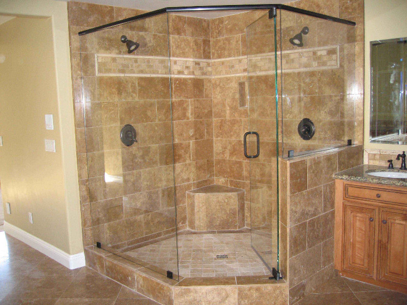 Design ideas for a large traditional master bathroom in New York with raised-panel cabinets, dark wood cabinets, a corner shower, beige tile, brown tile, ceramic tile, beige walls, travertine floors, an undermount sink, granite benchtops, brown floor and a hinged shower door.