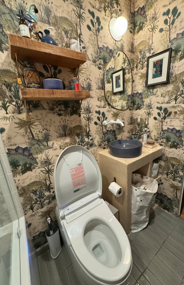 Photo of a mid-sized tropical 3/4 bathroom in Los Angeles with beige cabinets, a japanese tub, porcelain tile, ceramic floors, solid surface benchtops, a niche and wallpaper.