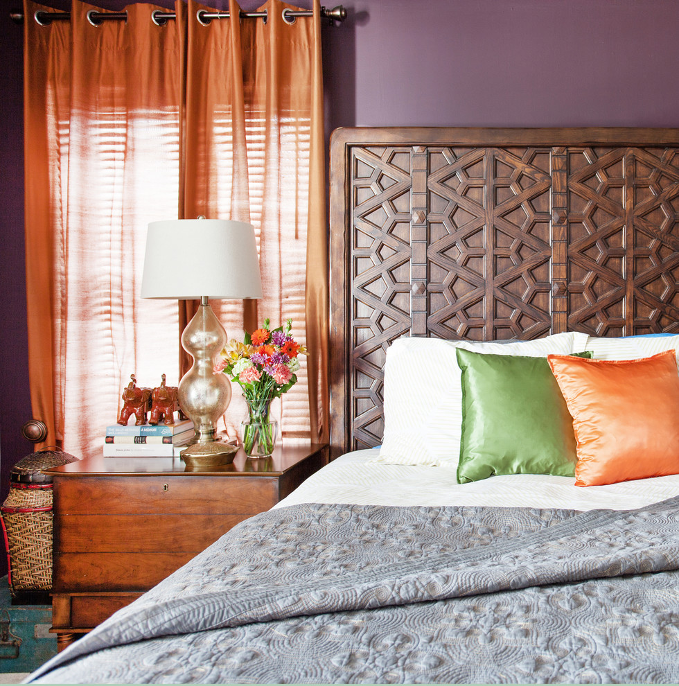 Photo of a mid-sized eclectic master bedroom in New York with purple walls, carpet and no fireplace.