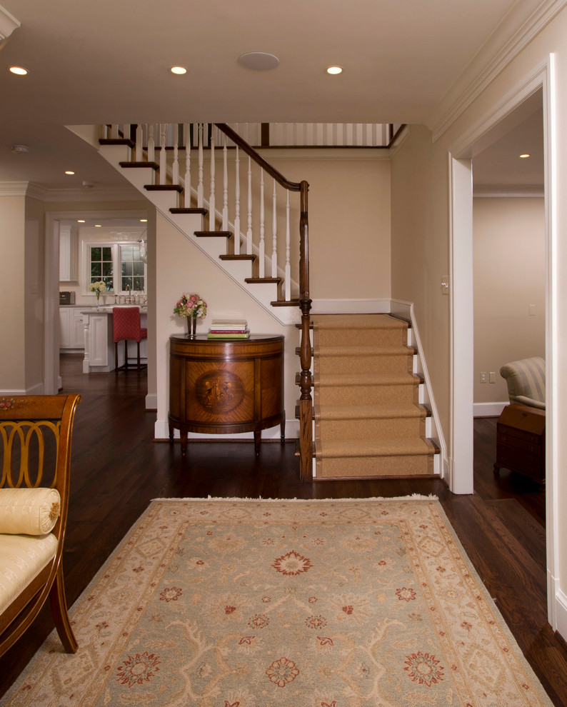 Photo of a large transitional entryway in DC Metro with beige walls and dark hardwood floors.