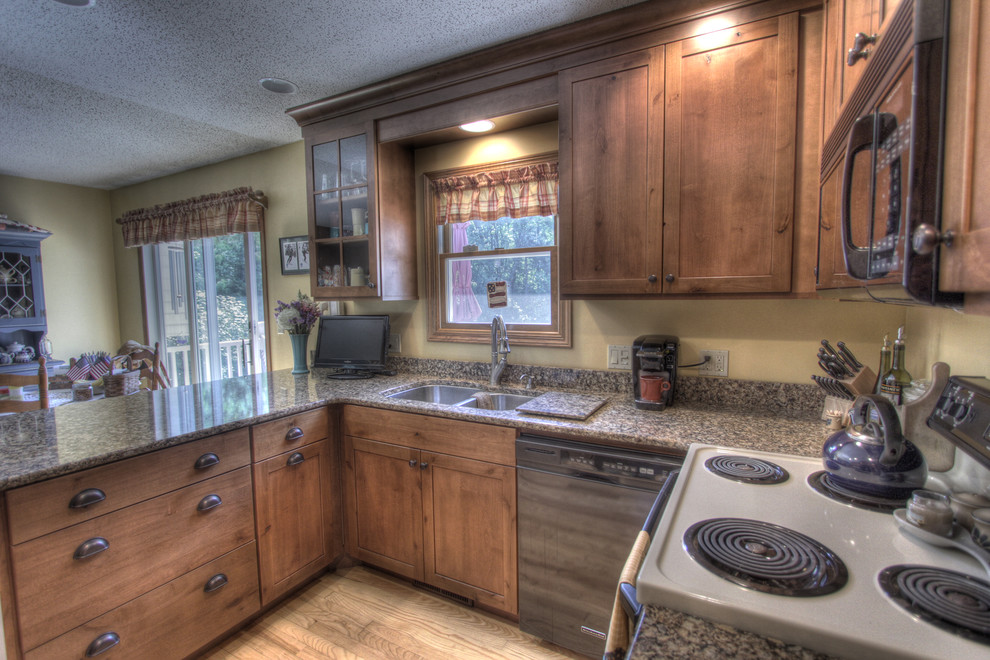Inspiration for a rustic u-shaped eat-in kitchen remodel with an undermount sink, shaker cabinets, medium tone wood cabinets, quartz countertops and black appliances