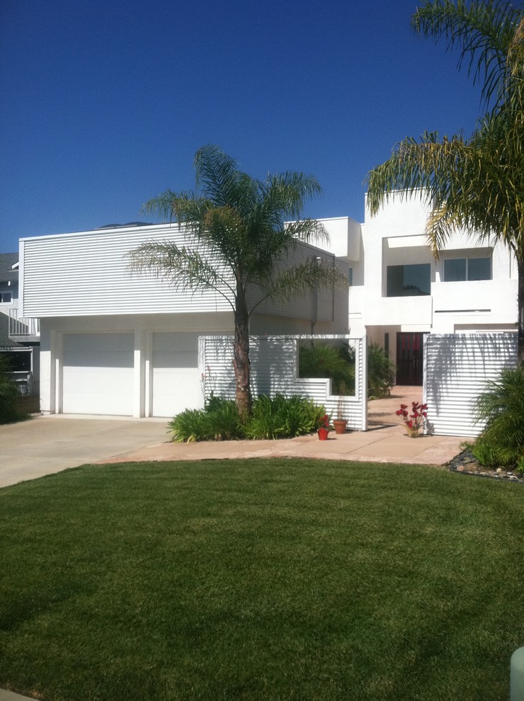 Inspiration for a contemporary two-storey white exterior in San Diego with mixed siding.
