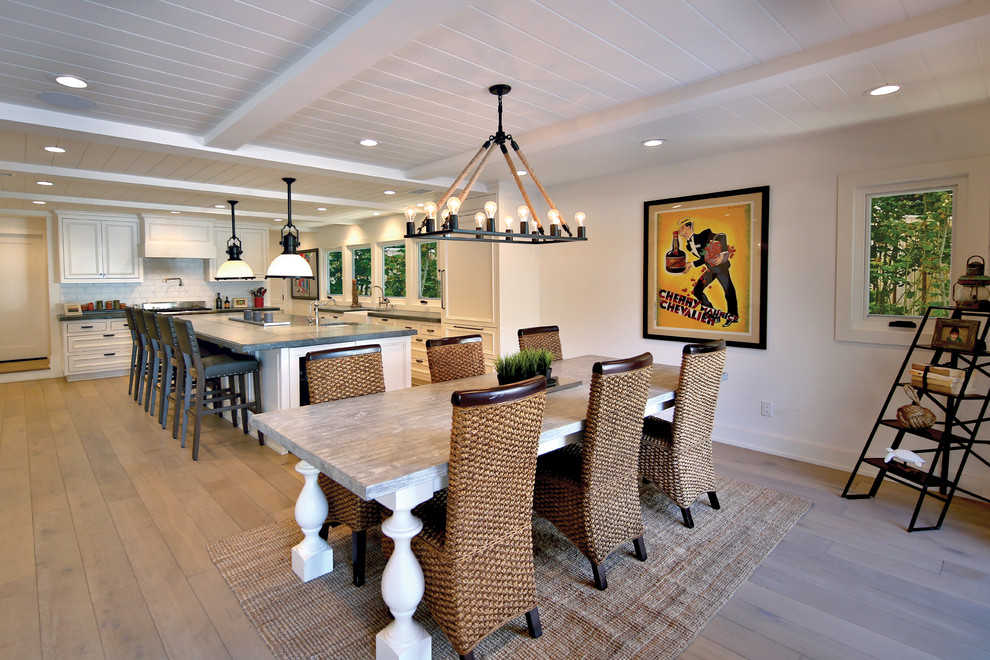 This is an example of a large traditional kitchen/dining combo in Orange County with white walls and light hardwood floors.