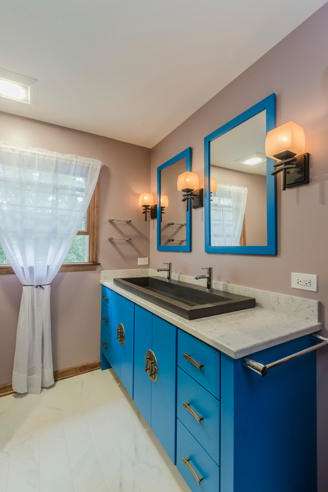 Mid-sized asian kids bathroom in Chicago with a trough sink, flat-panel cabinets, blue cabinets, engineered quartz benchtops, an alcove tub, an alcove shower, a two-piece toilet, gray tile, porcelain tile, purple walls and porcelain floors.