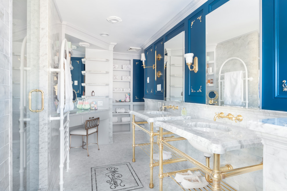 Inspiration for a mid-sized timeless master gray tile and marble tile marble floor and gray floor freestanding bathtub remodel in Boston with a one-piece toilet, blue walls, an undermount sink, marble countertops, a hinged shower door and gray countertops