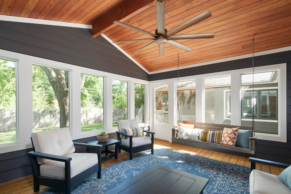 This is an example of a small country sunroom in Austin with medium hardwood floors, a standard ceiling and brown floor.