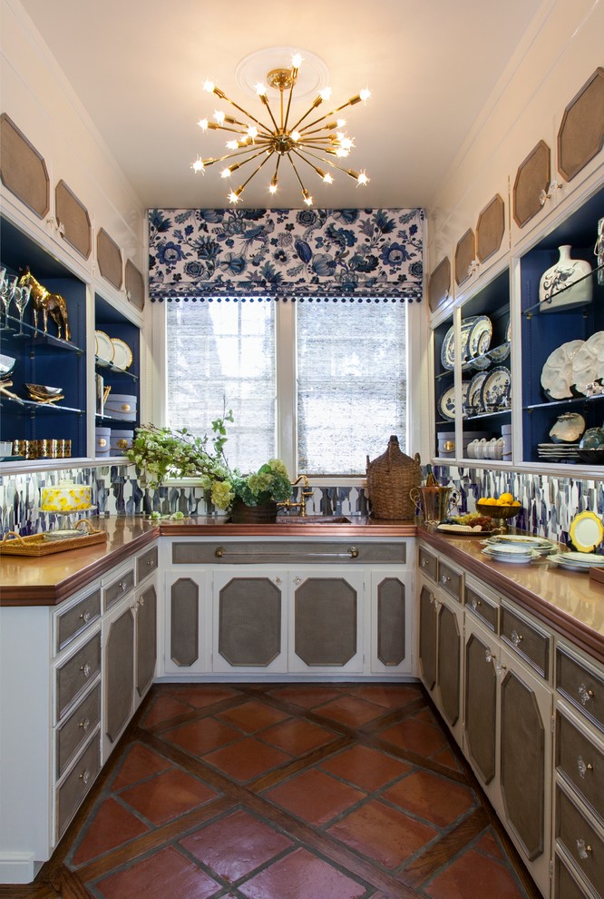 This is an example of a small traditional u-shaped kitchen pantry in San Francisco with open cabinets, copper benchtops, terra-cotta floors, an integrated sink, blue splashback, glass tile splashback and no island.