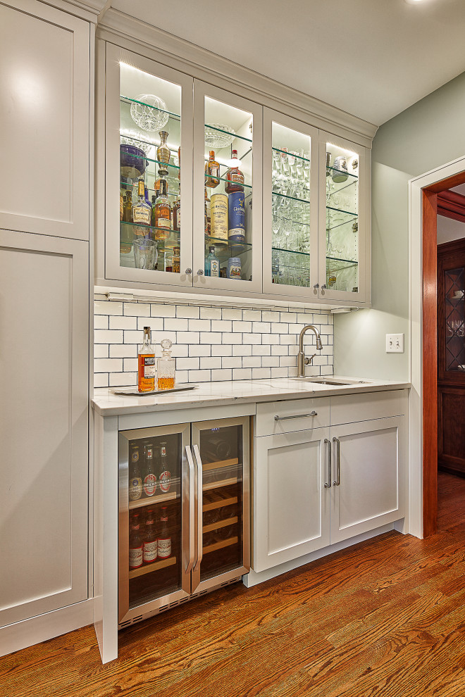 Design ideas for a classic home bar in Kansas City with shaker cabinets, white cabinets, engineered stone countertops, white splashback, metro tiled splashback and white worktops.