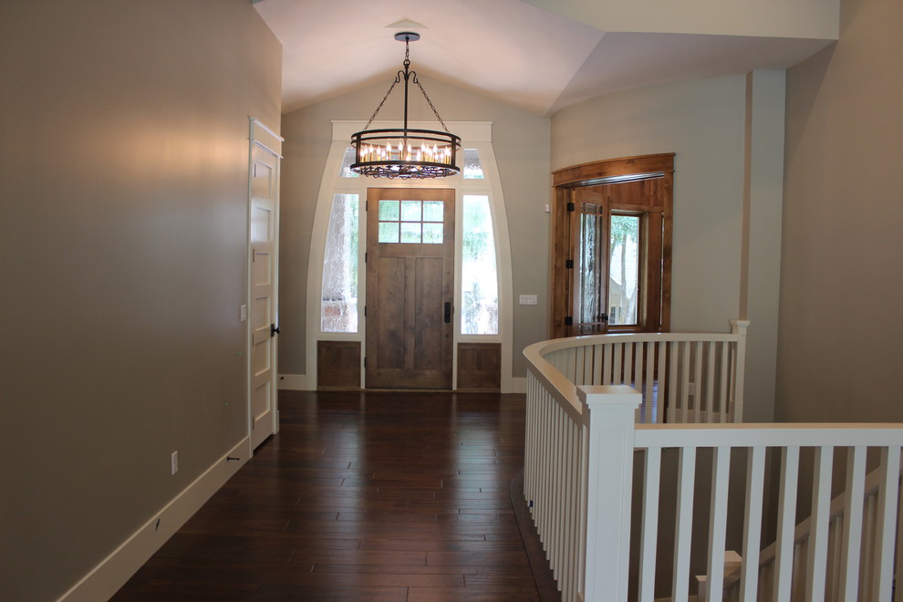 Design ideas for a large transitional foyer in Salt Lake City with grey walls, medium hardwood floors, a single front door and a medium wood front door.