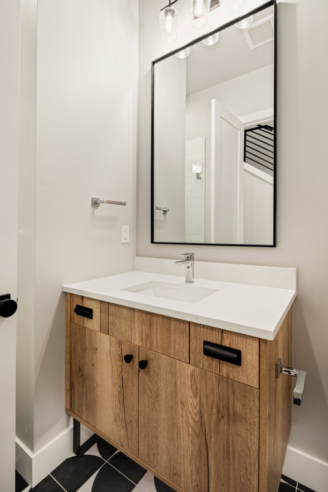 Design ideas for a medium sized contemporary cloakroom in Seattle with flat-panel cabinets, medium wood cabinets, a one-piece toilet, white tiles, grey walls, a submerged sink, white worktops and a built in vanity unit.