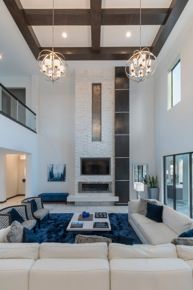 This is an example of an expansive contemporary open concept family room in Orlando with white walls, marble floors, a stone fireplace surround, a wall-mounted tv and white floor.