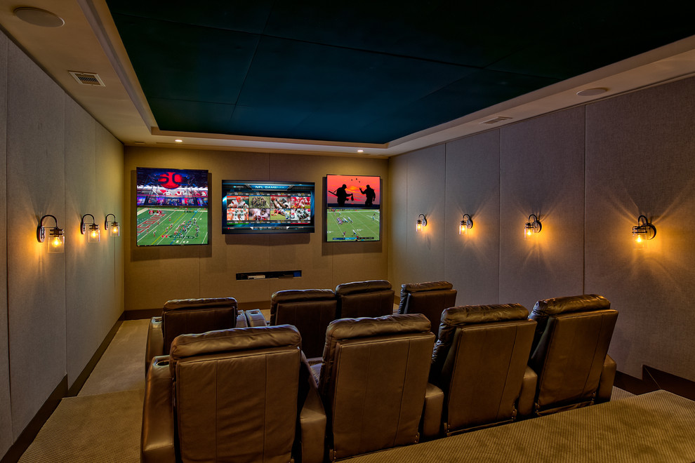 This is an example of a large traditional enclosed home theatre in Atlanta with beige walls, carpet, a wall-mounted tv and beige floor.