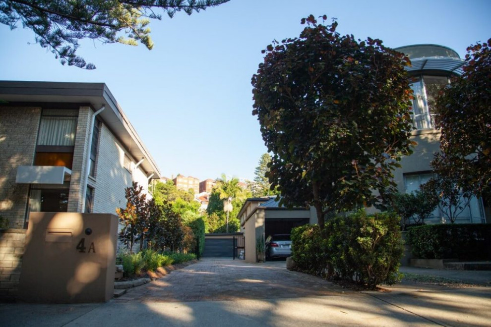 This is an example of a mid-sized contemporary side yard driveway in Sydney with a garden path and brick pavers.