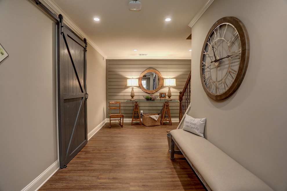 Photo of a large country hallway in Atlanta with grey walls, laminate floors and brown floor.
