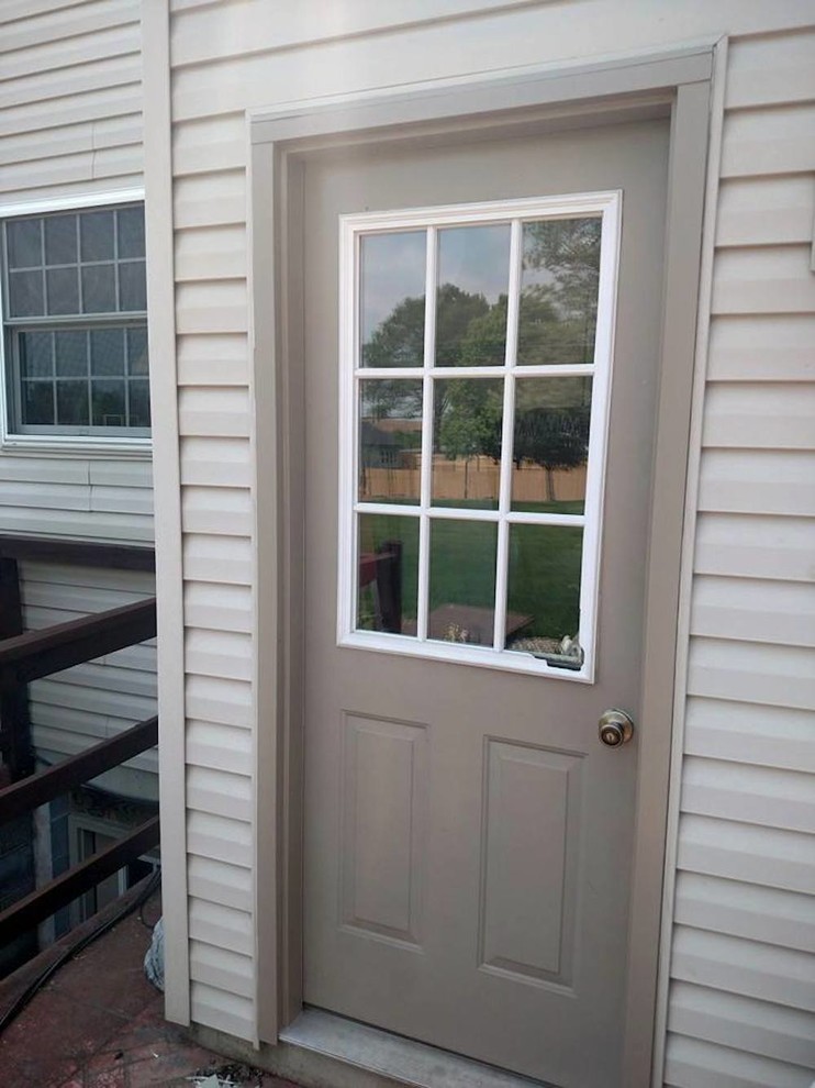 Front door - mid-sized transitional front door idea with a brown front door
