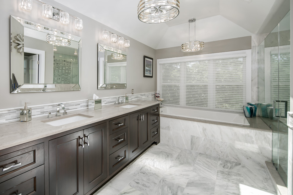 Mid-sized transitional master bathroom in DC Metro with shaker cabinets, dark wood cabinets, a drop-in tub, an alcove shower, grey walls, marble floors, an undermount sink, white floor and a hinged shower door.