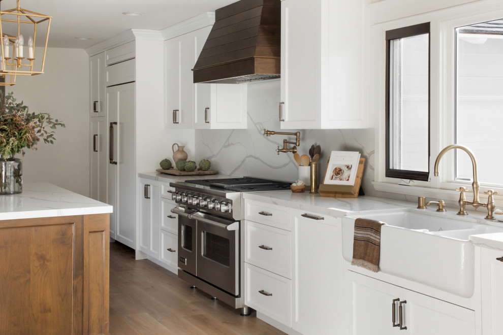 Example of a large country galley eat-in kitchen design in Los Angeles with recessed-panel cabinets and an island