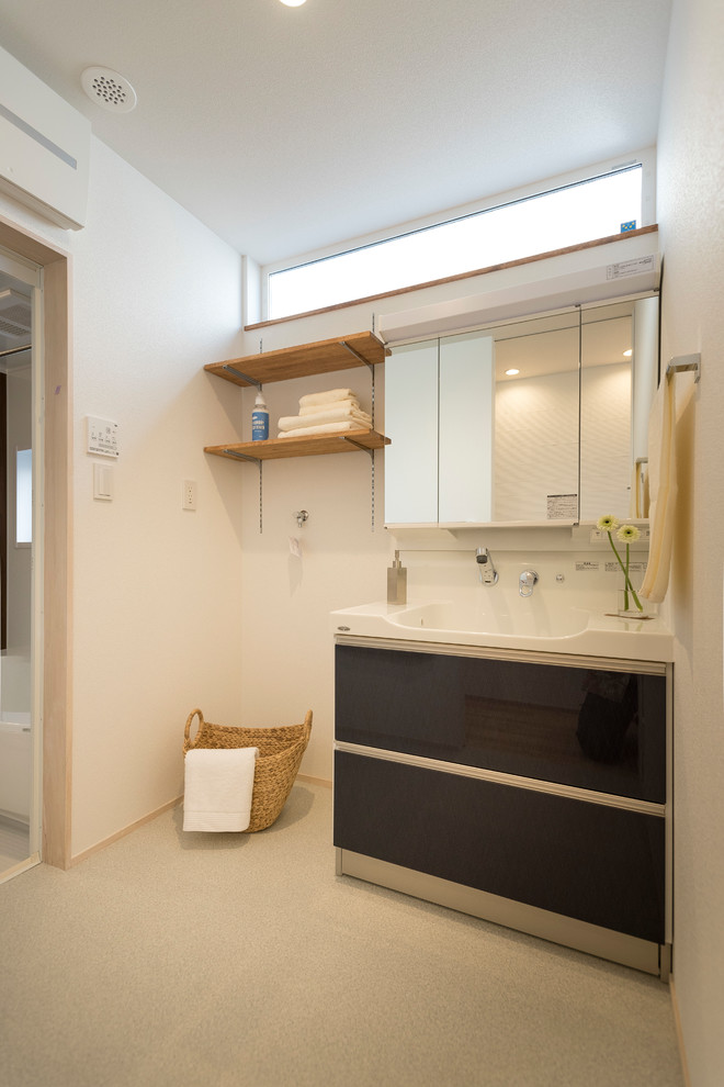 This is an example of a contemporary bathroom in Nagoya with flat-panel cabinets, dark wood cabinets, white walls and grey floor.