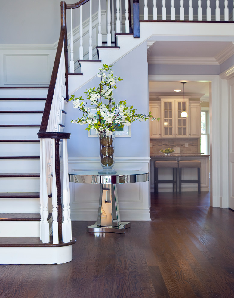 Inspiration for a traditional foyer in New York with blue walls and dark hardwood floors.
