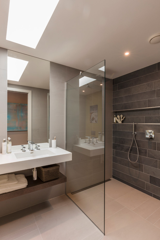 Inspiration for a mid-sized contemporary 3/4 bathroom in Hertfordshire with open cabinets, a curbless shower, beige tile, beige walls, ceramic floors and an undermount sink.