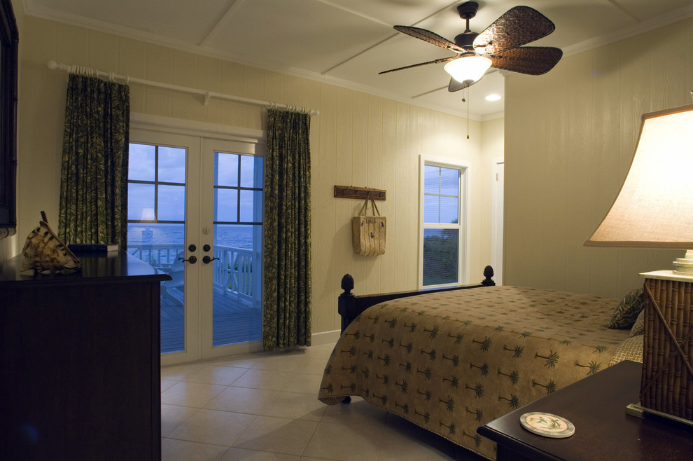 This is an example of a large beach style master bedroom in Grand Rapids with green walls and limestone floors.