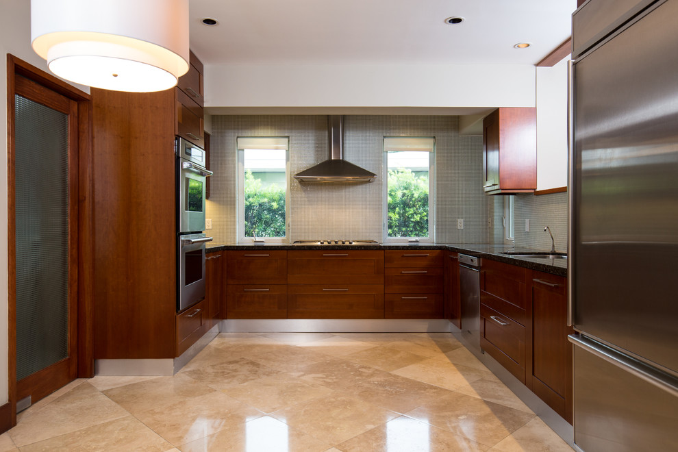 Inspiration for a mid-sized contemporary u-shaped separate kitchen in Miami with an undermount sink, shaker cabinets, medium wood cabinets, granite benchtops, green splashback, glass tile splashback, stainless steel appliances, marble floors, no island and beige floor.