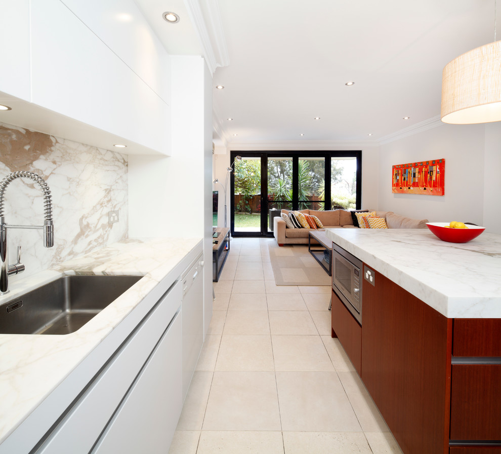 This is an example of a small contemporary u-shaped eat-in kitchen in Sydney with a drop-in sink, flat-panel cabinets, medium wood cabinets, marble benchtops, stone slab splashback, stainless steel appliances, ceramic floors, with island and multi-coloured splashback.