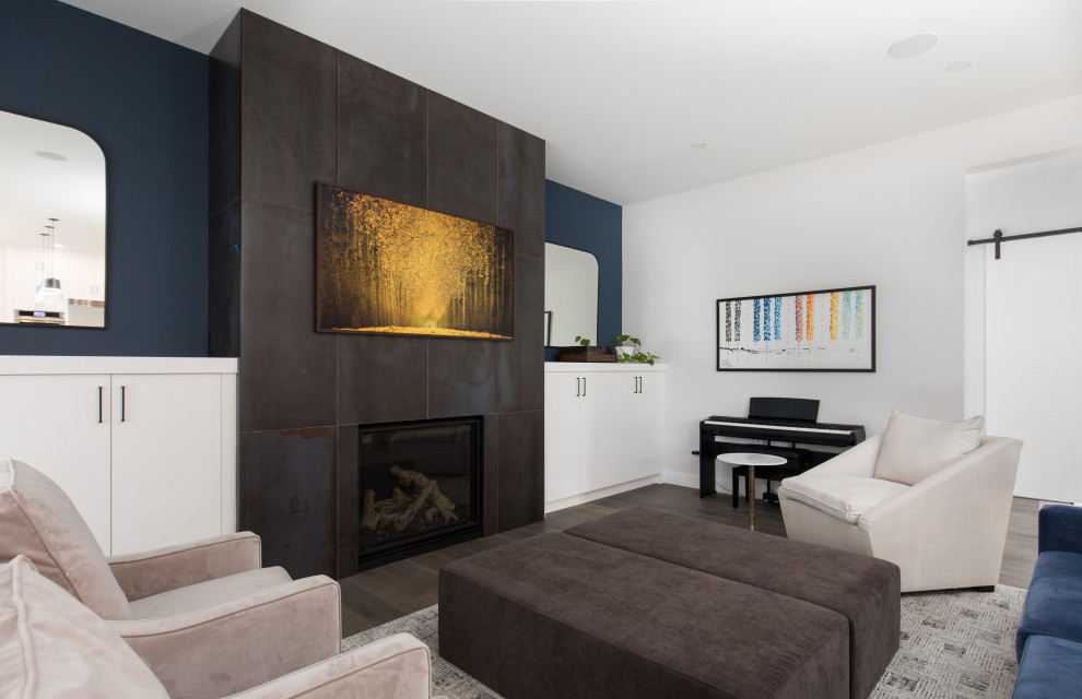 Example of a large transitional open concept dark wood floor and gray floor living room design in Calgary with a music area, white walls, a standard fireplace, a tile fireplace and a wall-mounted tv