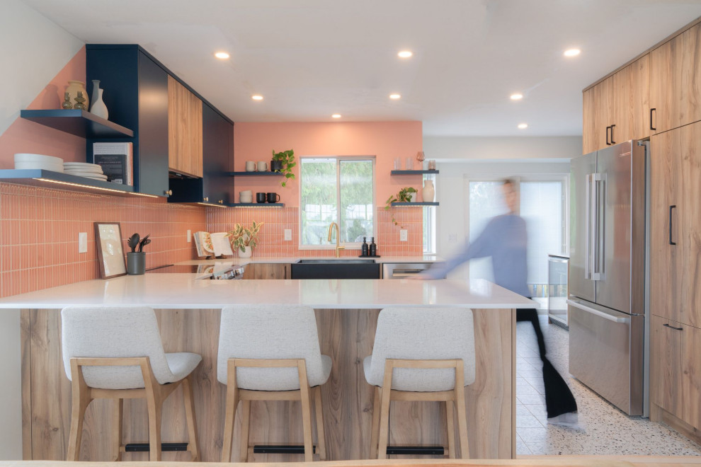 Small transitional u-shaped terrazzo floor and white floor eat-in kitchen photo in Vancouver with a farmhouse sink, flat-panel cabinets, light wood cabinets, quartz countertops, pink backsplash, porcelain backsplash, stainless steel appliances, an island and white countertops